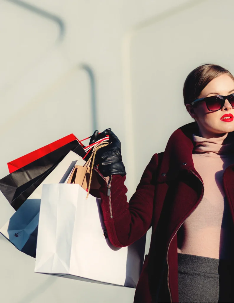Shopper carrying paper shopping bags
