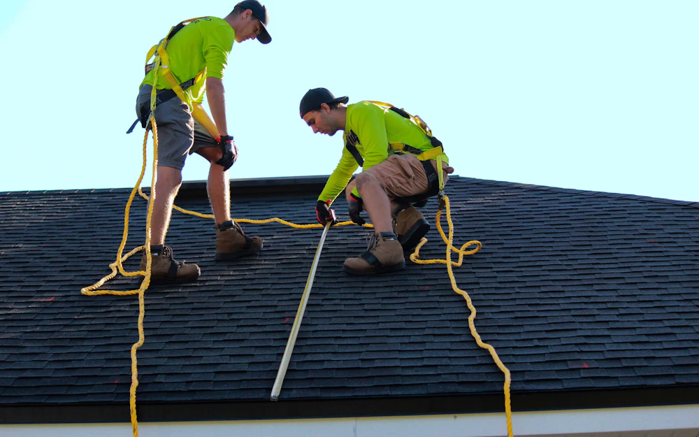 Roofing contractors working on a house roof