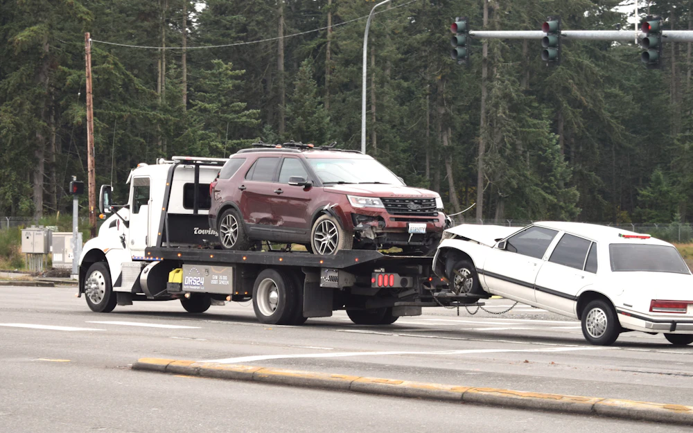 Tow truck carrying a vehicle on the road